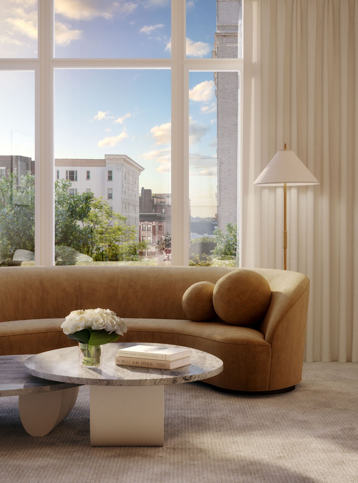 A spacious living room with large window and comfortable couch at The Henry Residences by Naftali Group, 211 West 84th St.