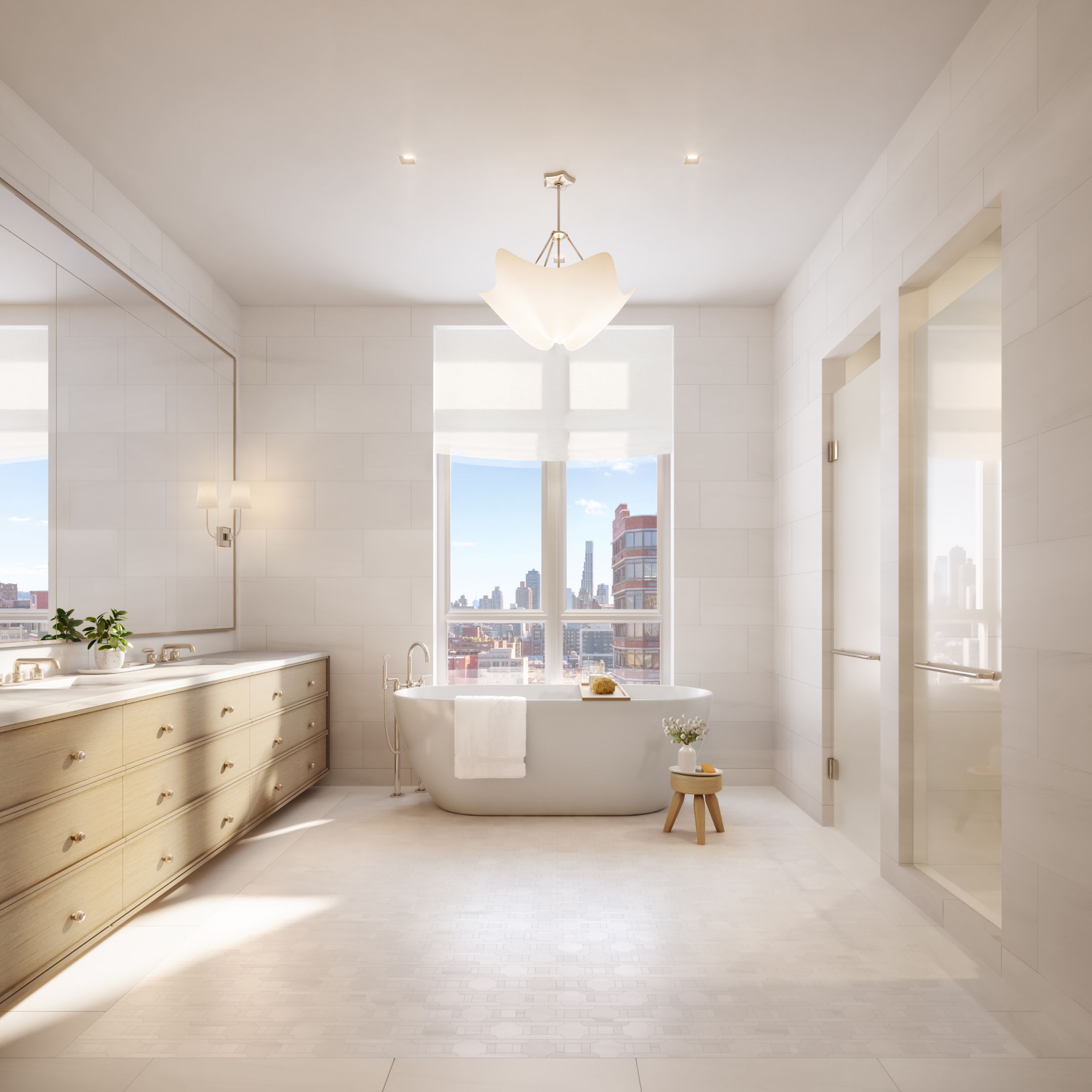 Luxurious bathroom with a large tub and huge window at The Henry, Upper West Side condominiums by Naftali Group..