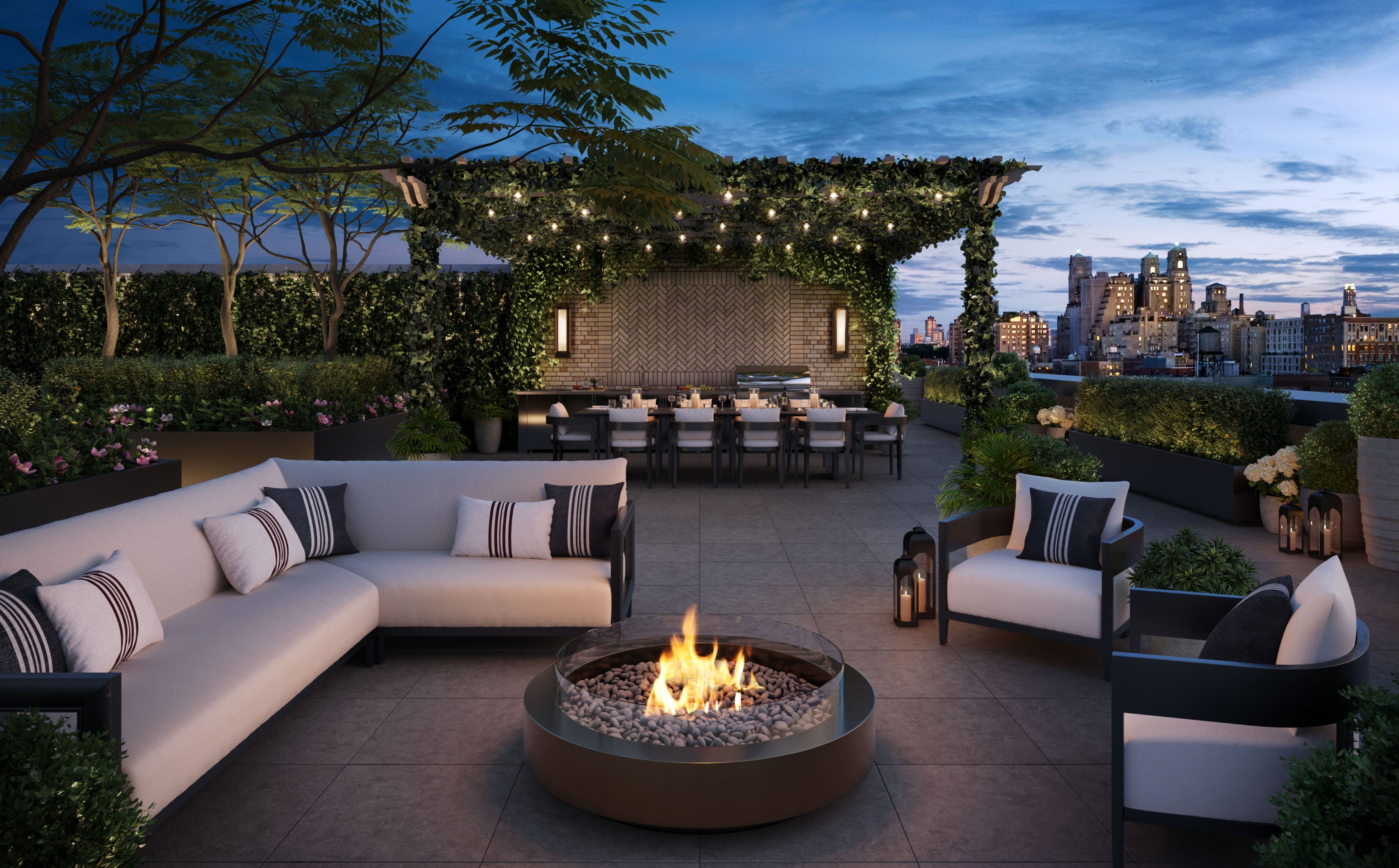 A rooftop terrace with a cozy fire pit and seating area, part of amenities at The Henry Residences in the Upper West Side.