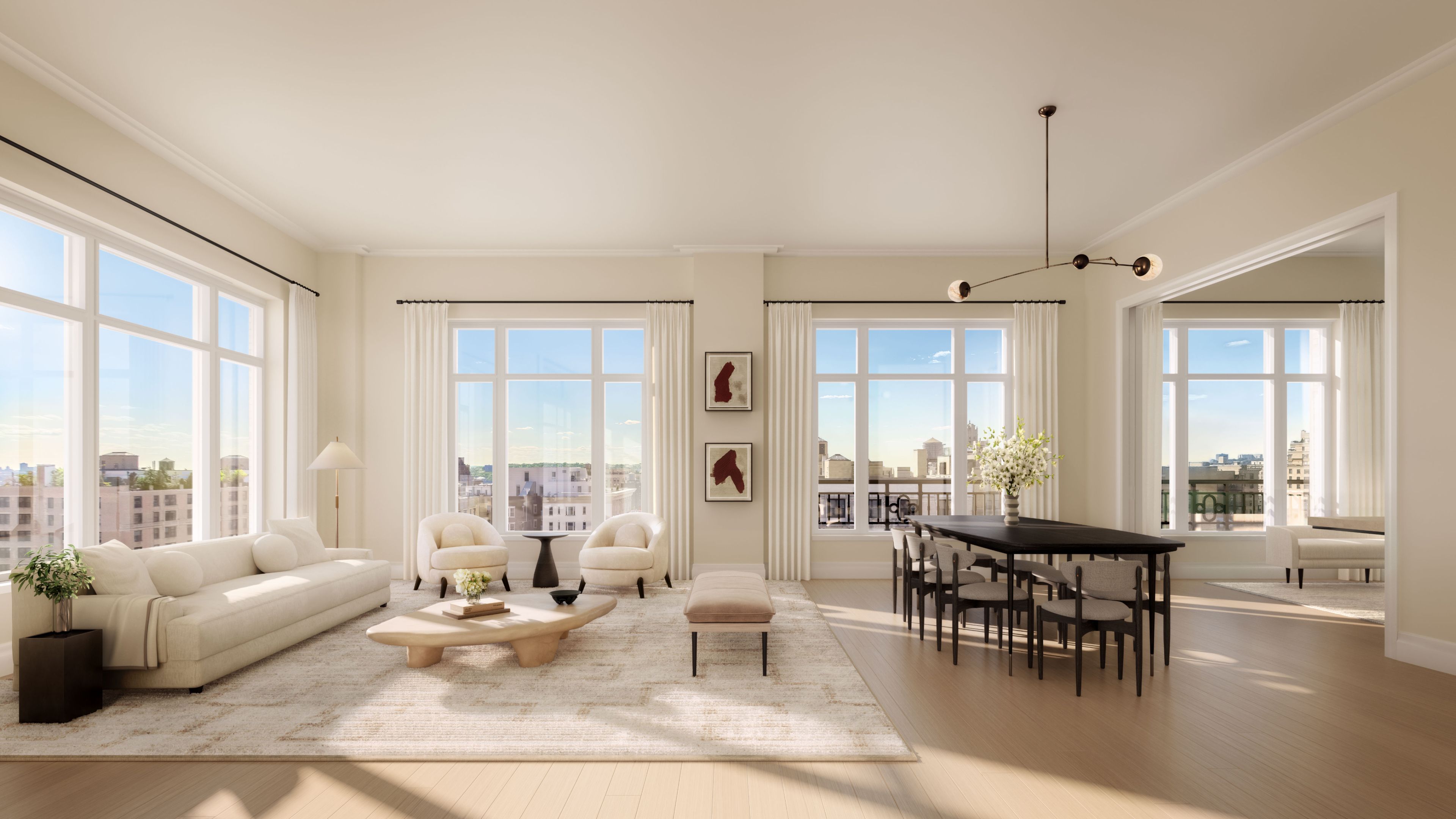 Elegant living room with expansive windows and white furnishings at The Henry Residences, Upper West Side new development.