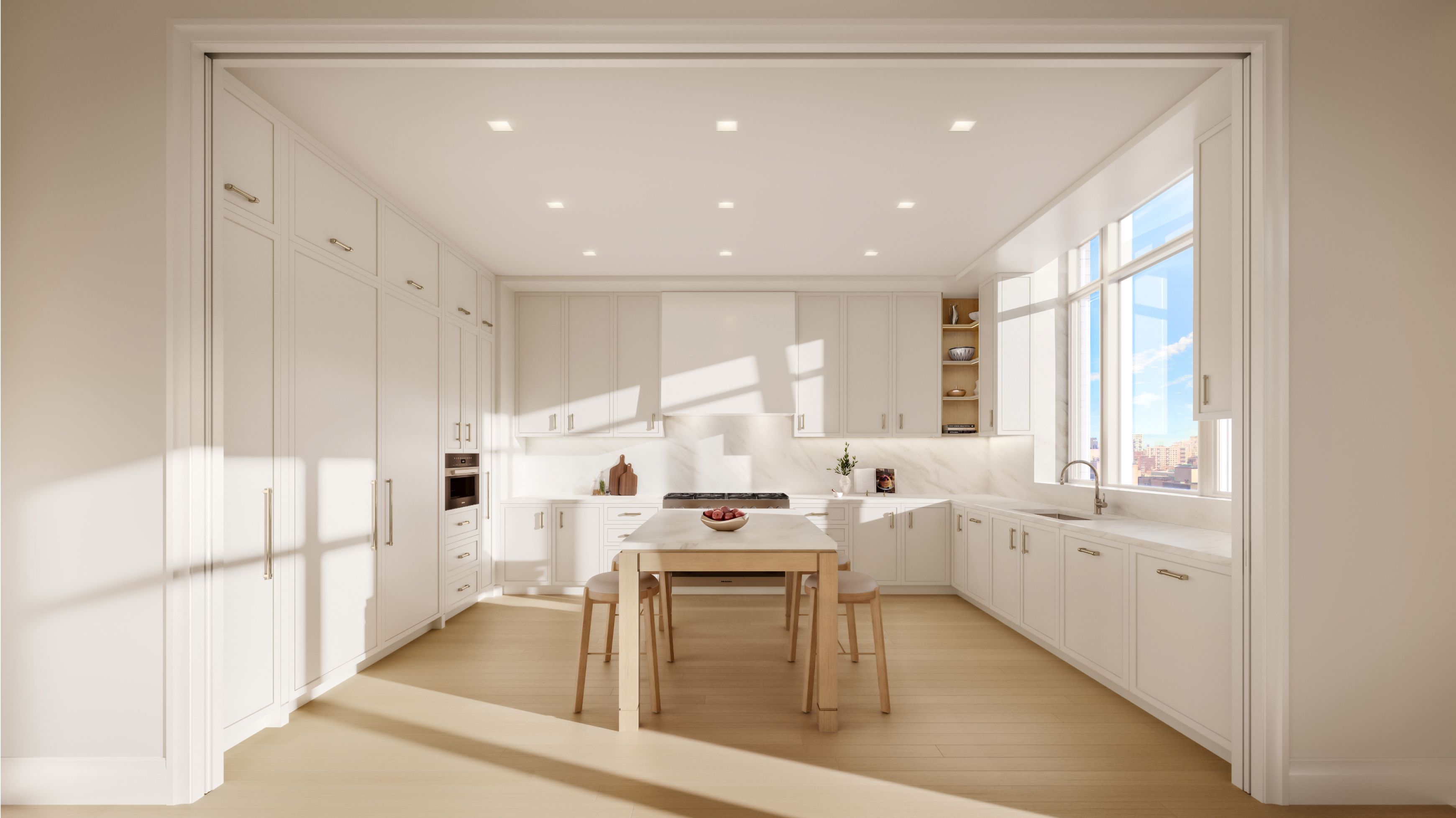 Elegant kitchen with dining table and white cabinetry at a condo at The Henry Residences by Naftali Group in the UWS.