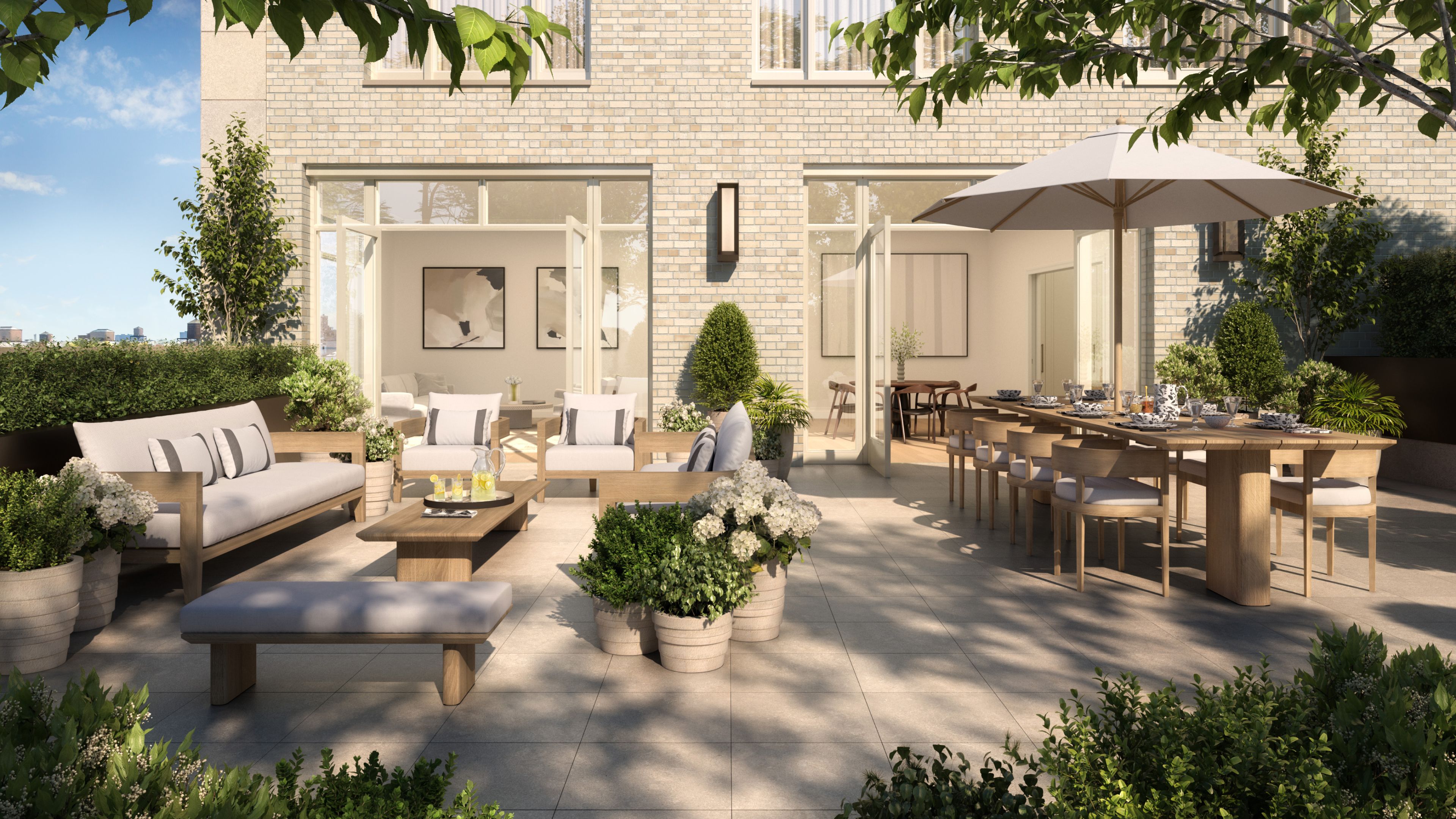 The terrace at The Henry UWS condominiums with outdoor seating and greenery, perfect for enjoying the outdoors.